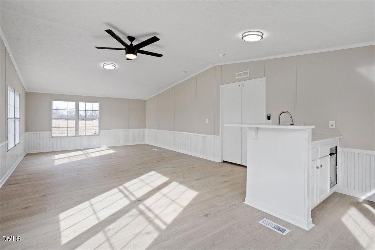 371 Woodland Church Road Dudley, NC 28333 - Photo 13 of 30 a view of livingroom with hardwood floor and a ceiling fan