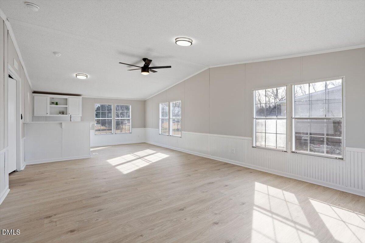 371 Woodland Church Road Dudley, NC 28333 - Photo 14 of 30 a view of an empty room with a window and wooden floor