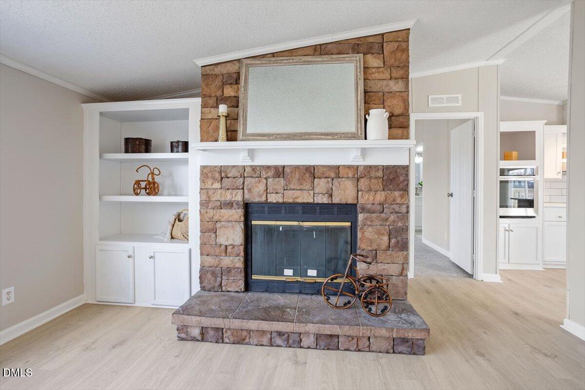 371 Woodland Church Road Dudley, NC 28333 - Photo 15 of 30 a living room with furniture and a fireplace