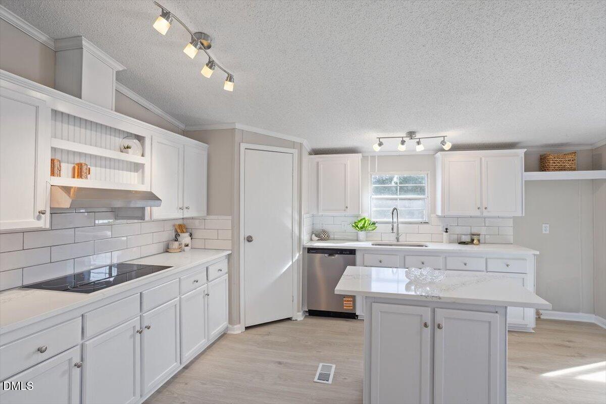 371 Woodland Church Road Dudley, NC 28333 - Photo 2 of 30 a kitchen with a sink stove and cabinets
