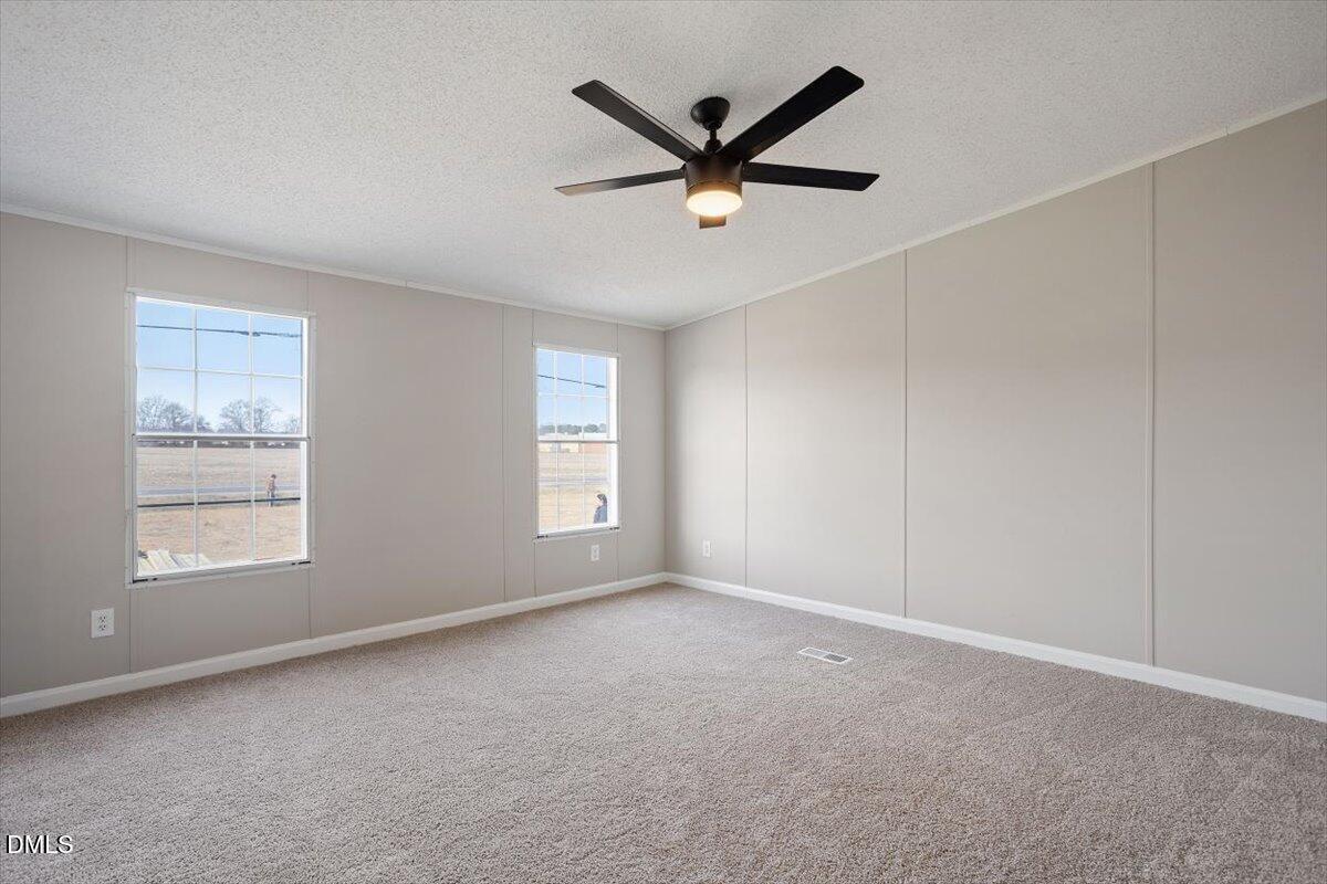 371 Woodland Church Road Dudley, NC 28333 - Photo 21 of 30 a view of a livingroom with a ceiling fan and window