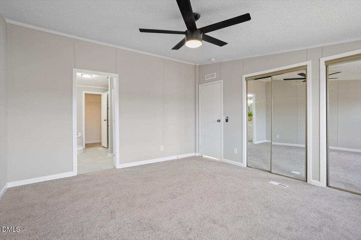 371 Woodland Church Road Dudley, NC 28333 - Photo 22 of 30 a view of an empty room and a ceiling fan