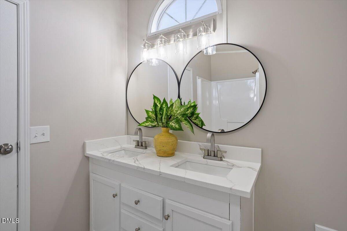 371 Woodland Church Road Dudley, NC 28333 - Photo 25 of 30 a bathroom with a sink a mirror and vanity