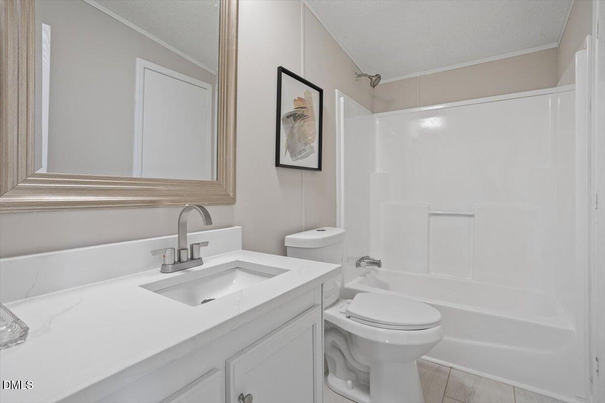 371 Woodland Church Road Dudley, NC 28333 - Photo 28 of 30 a bathroom with a sink toilet and vanity