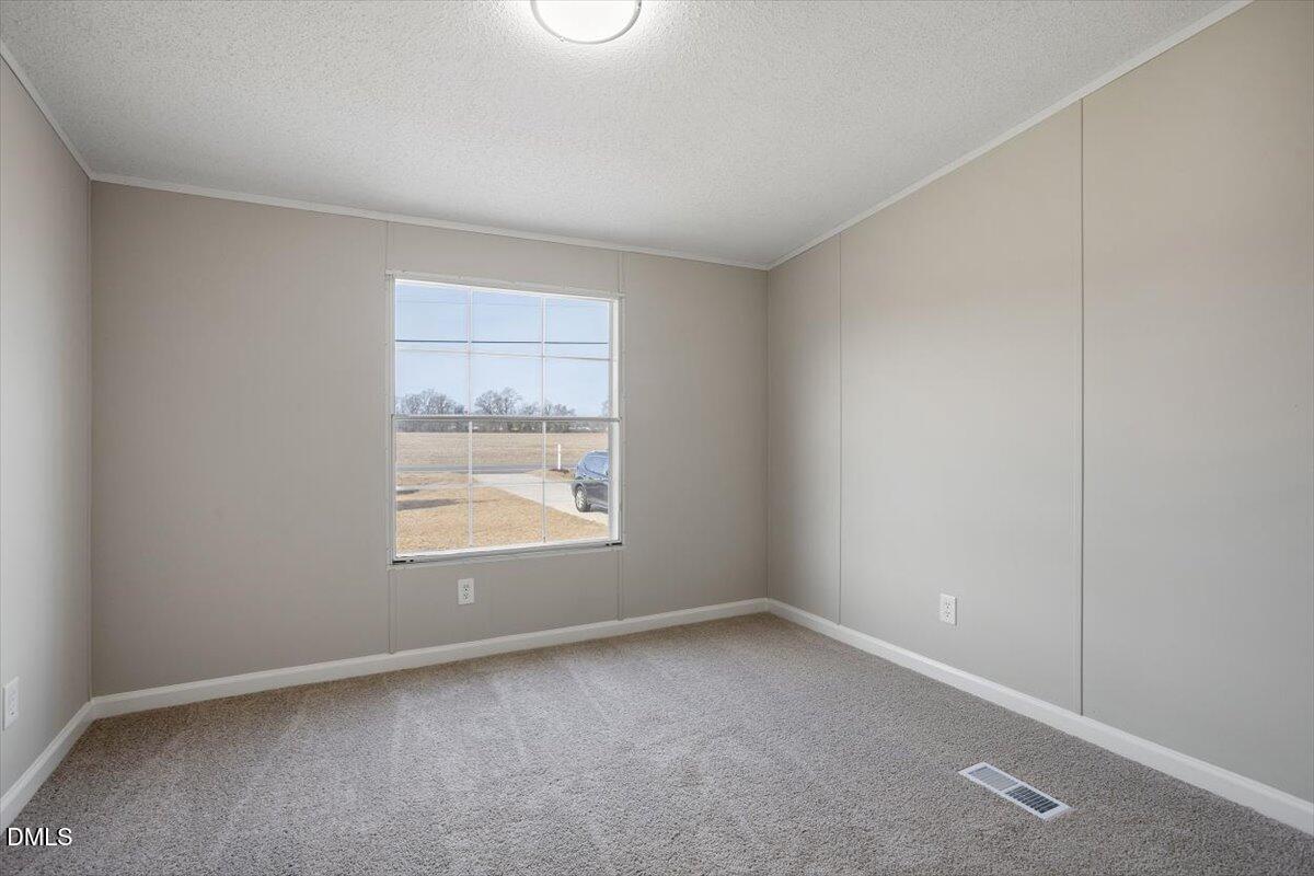 371 Woodland Church Road Dudley, NC 28333 - Photo 29 of 30 an empty room with a window