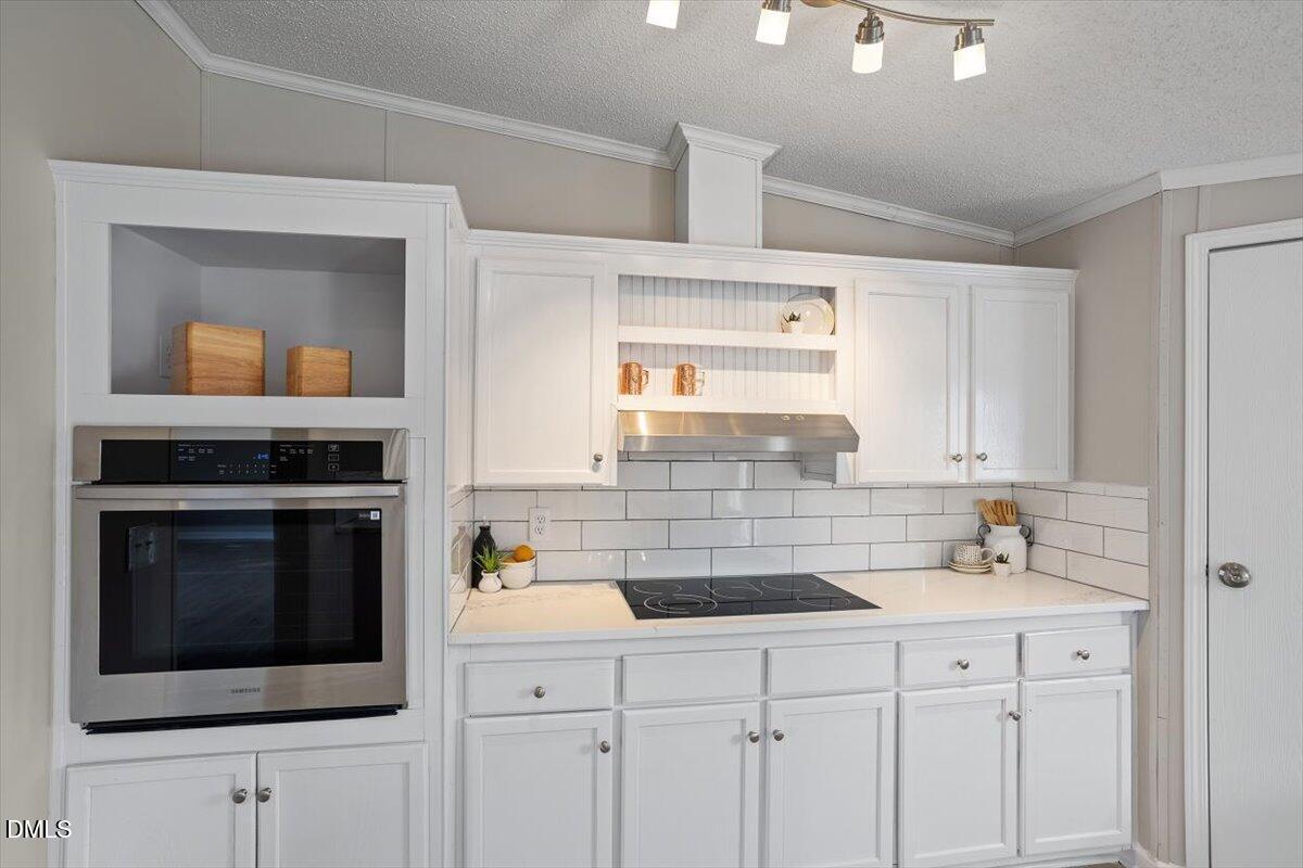 371 Woodland Church Road Dudley, NC 28333 - Photo 3 of 30 a kitchen with a sink and a microwave