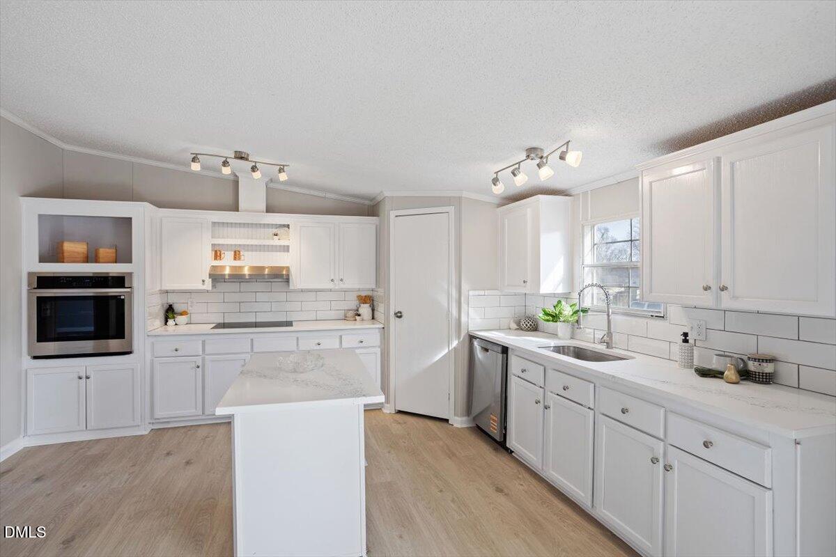 371 Woodland Church Road Dudley, NC 28333 - Photo 5 of 30 a kitchen with a sink cabinets and window