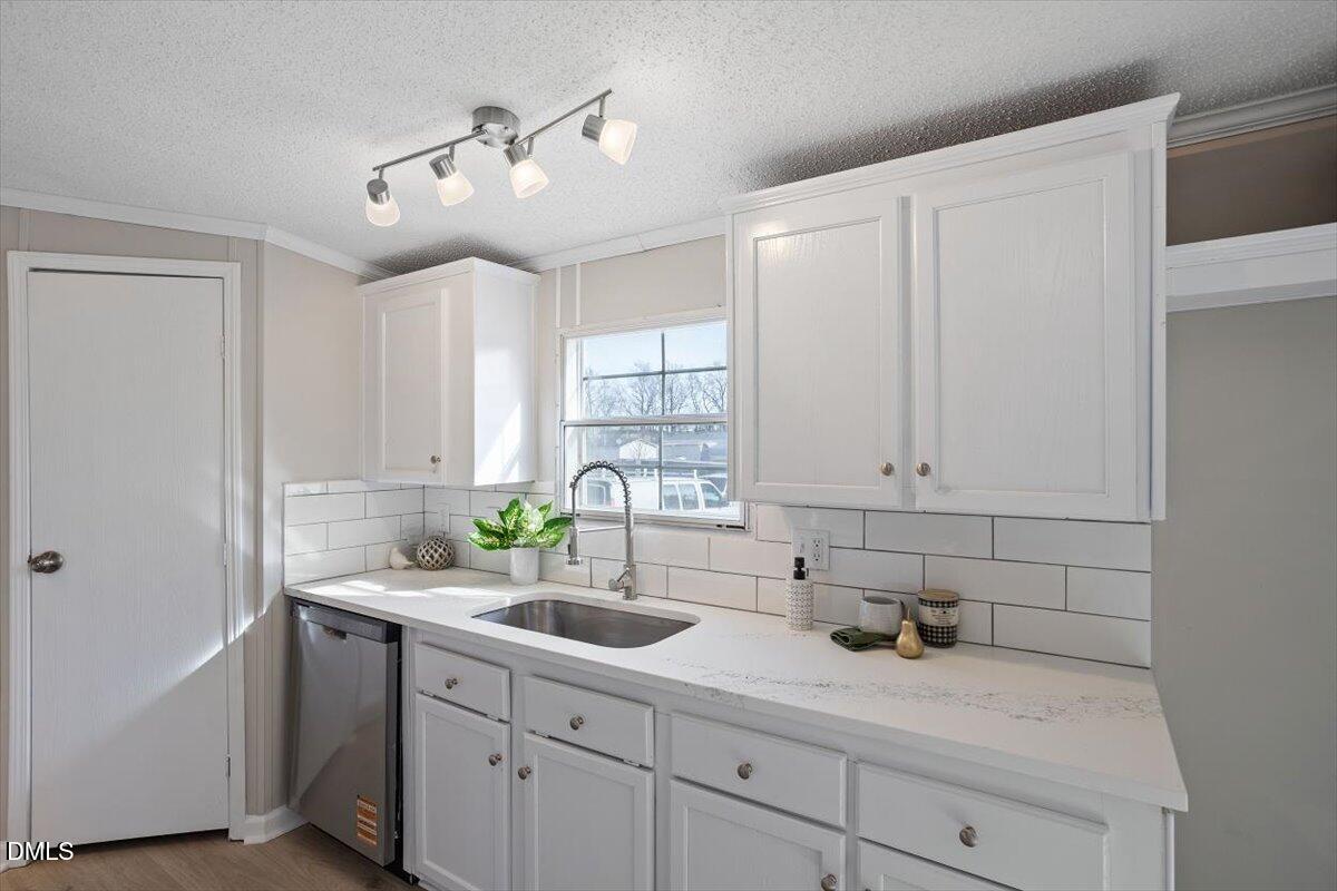 371 Woodland Church Road Dudley, NC 28333 - Photo 7 of 30 a kitchen with a sink cabinets and window