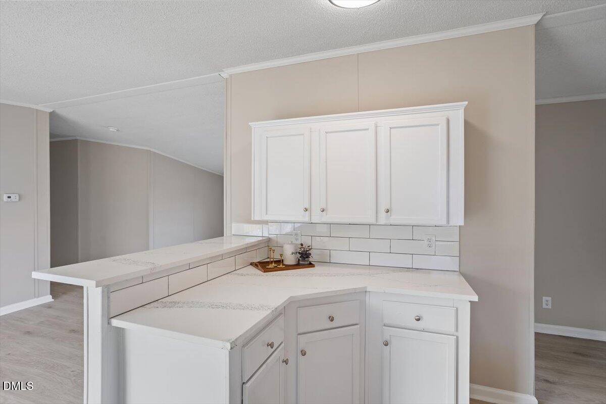 371 Woodland Church Road Dudley, NC 28333 - Photo 8 of 30 a kitchen with a sink cabinets and white appliances