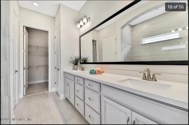 a en suite bathroom with a granite countertop shower