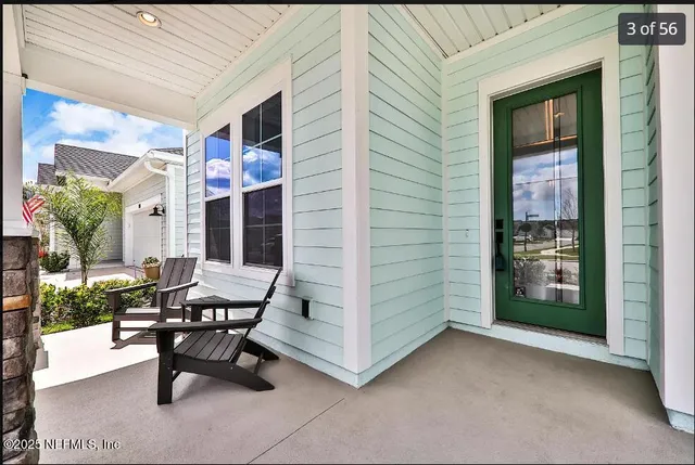 a building outdoor space with patio furniture and potted plants