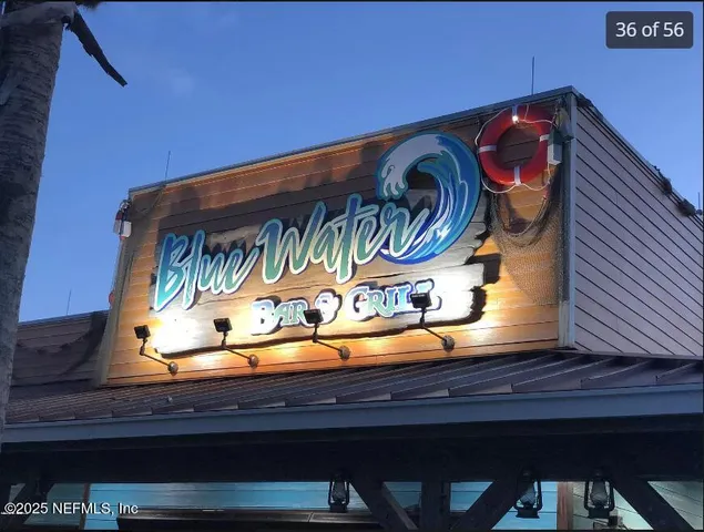 a view of swimming pool with lawn chairs and a yard