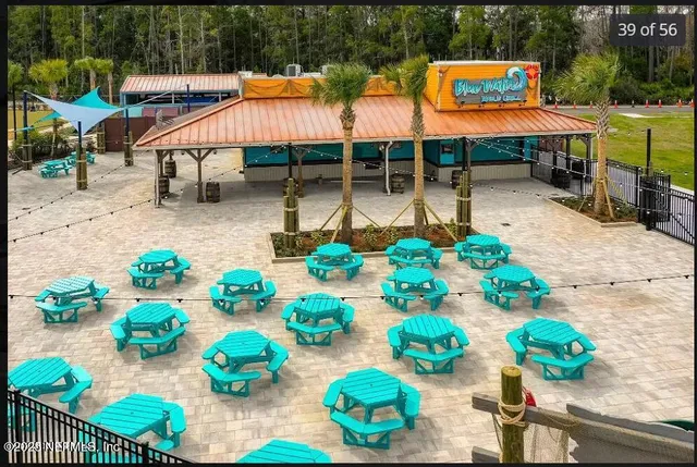 a view of a house with pool and sitting area