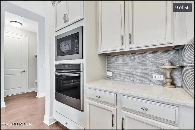 a living room with furniture and wall paintings