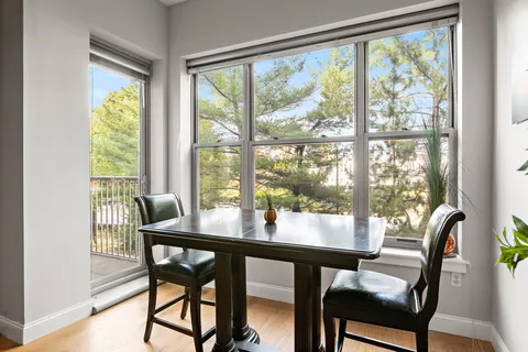 a view of a dining room with furniture and a window