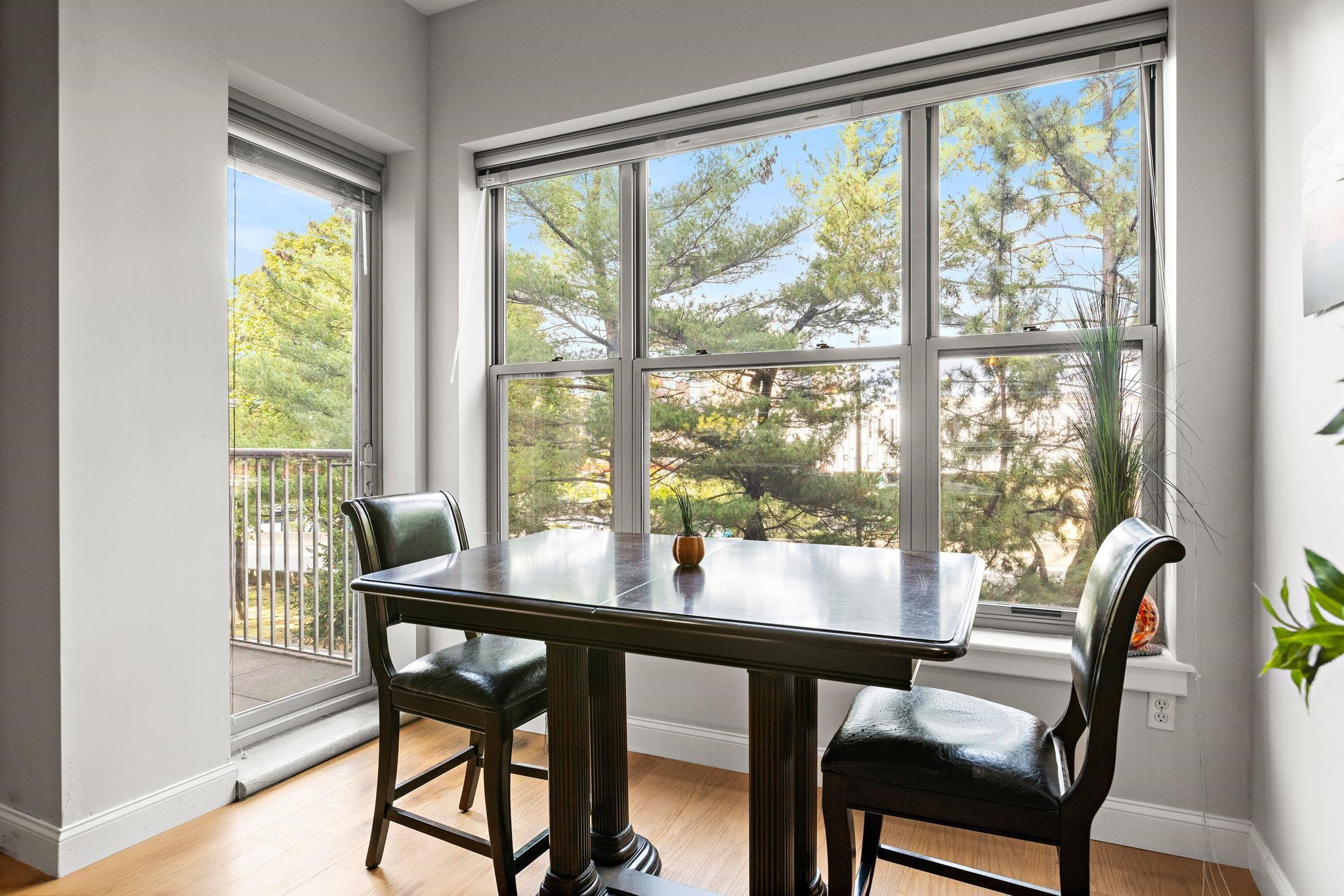 234 10th Street, Unit 306 Jersey City, NJ 07302 - Photo 2 of 15 a view of a dining room with furniture and a window