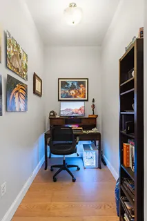 a reading room with furniture piano and a window