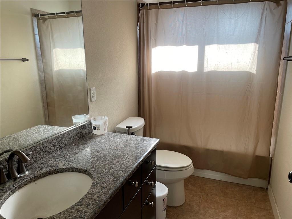 16309 McAloon Way Austin, TX 78728 - Photo 13 of 16 Full bath with vanity, shower / bath combo, and a textured wall
