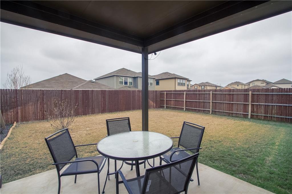 16309 McAloon Way Austin, TX 78728 - Photo 16 of 16 Fenced backyard featuring a patio and outdoor dining space