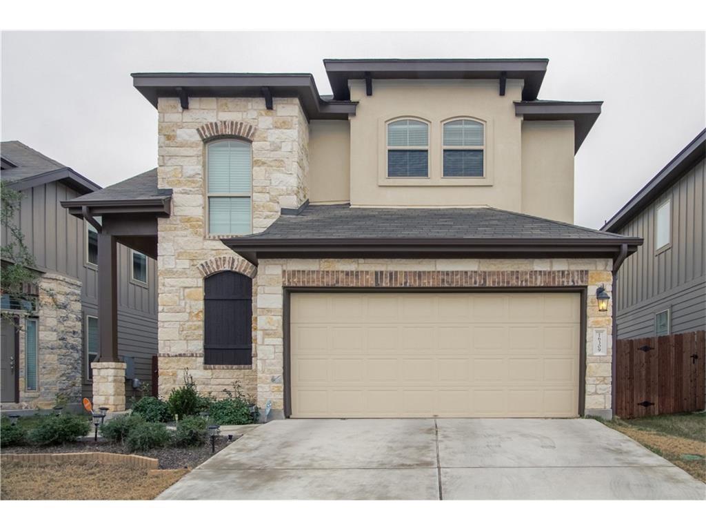 16309 McAloon Way Austin, TX 78728 - Photo 2 of 16 View of front of home featuring stone siding, driveway, an attached garage, and stucco siding