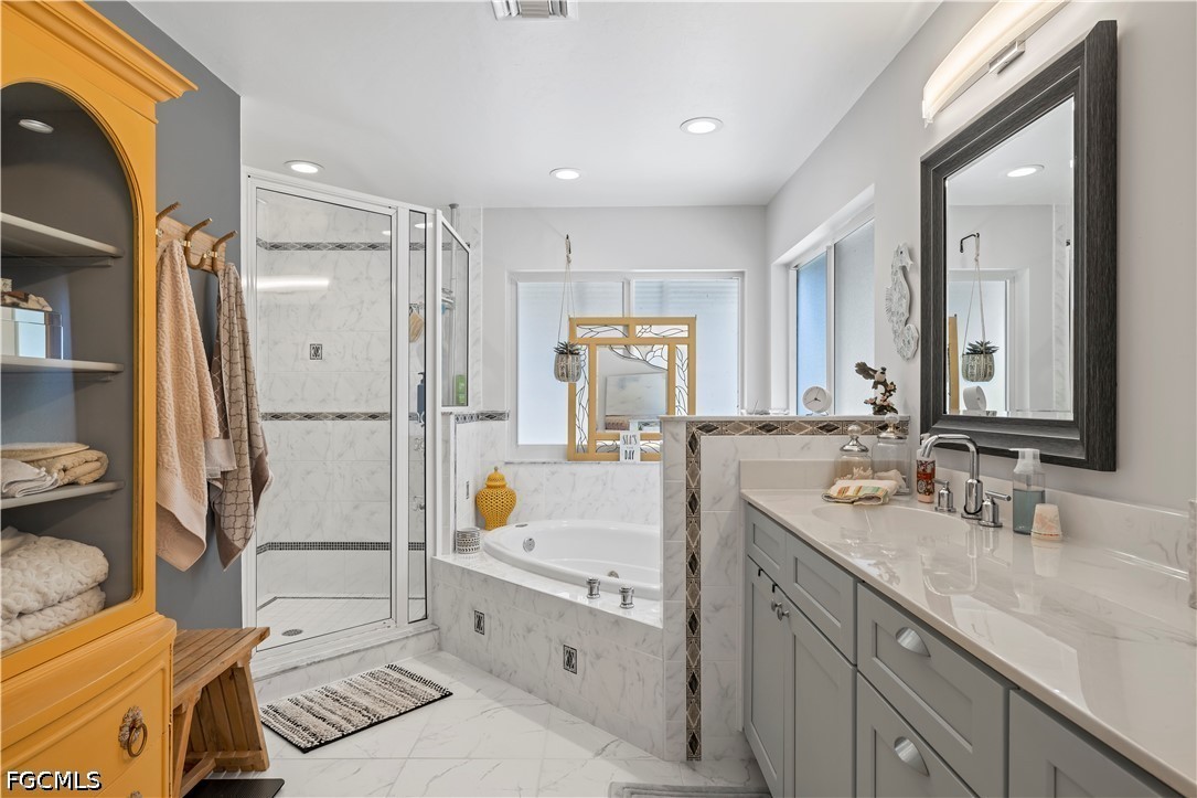 485 Peachtree Road Sanibel, FL 33957 - Photo 12 of 24 a spacious bathroom with a double vanity sink a mirror and a shower
