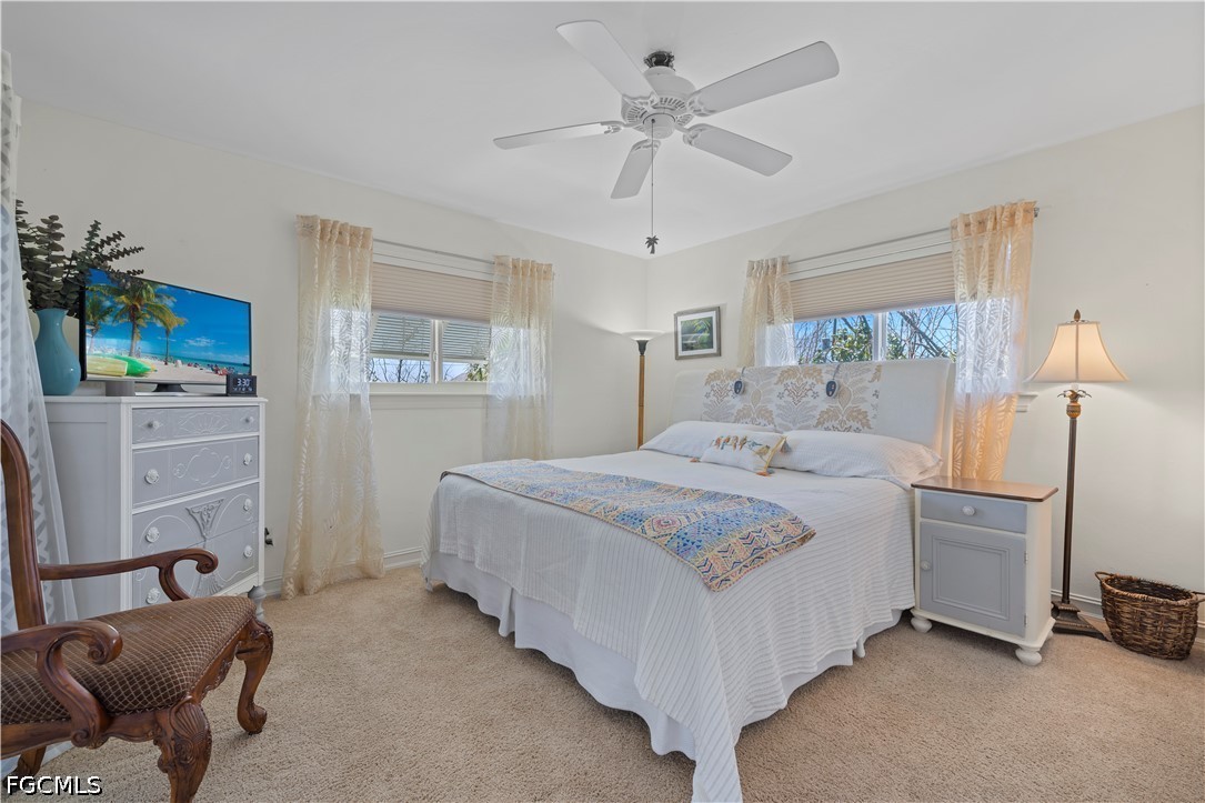 485 Peachtree Road Sanibel, FL 33957 - Photo 14 of 24 a bedroom with a bed and a chandelier