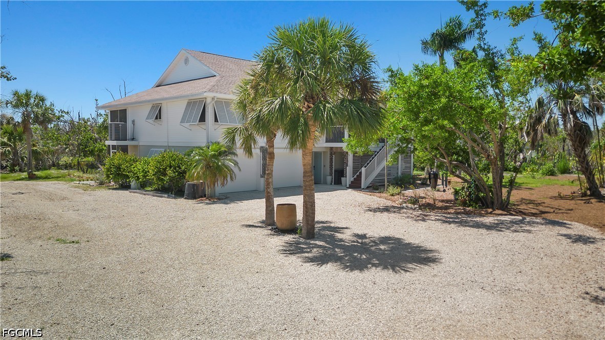 485 Peachtree Road Sanibel, FL 33957 - Photo 17 of 24 a view of a house with a yard