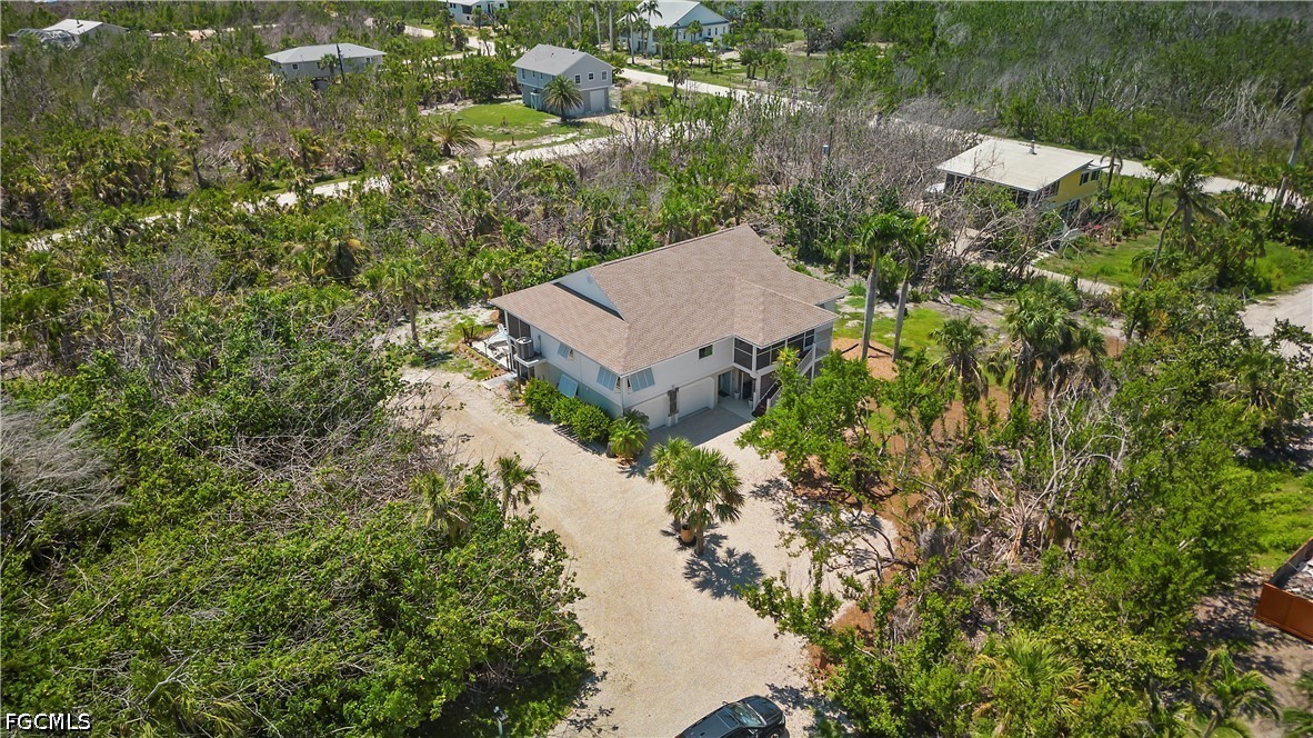 485 Peachtree Road Sanibel, FL 33957 - Photo 21 of 24 an aerial view of a house with a yard and lake view