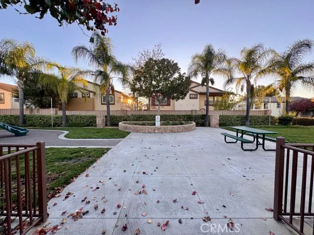 a row of palm trees in front of a house