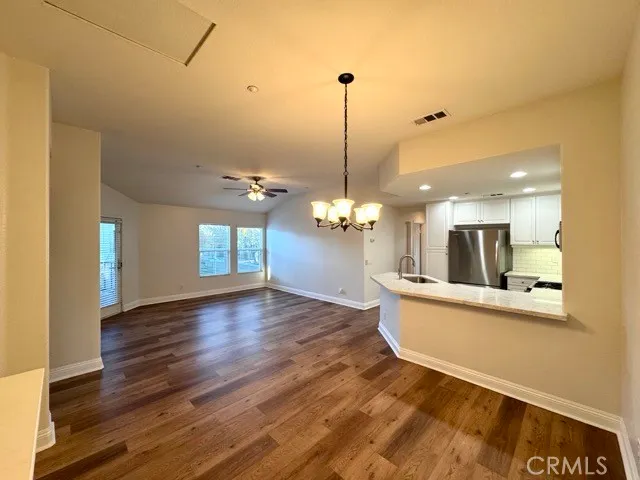 a view of a room with wooden floor and potted plant