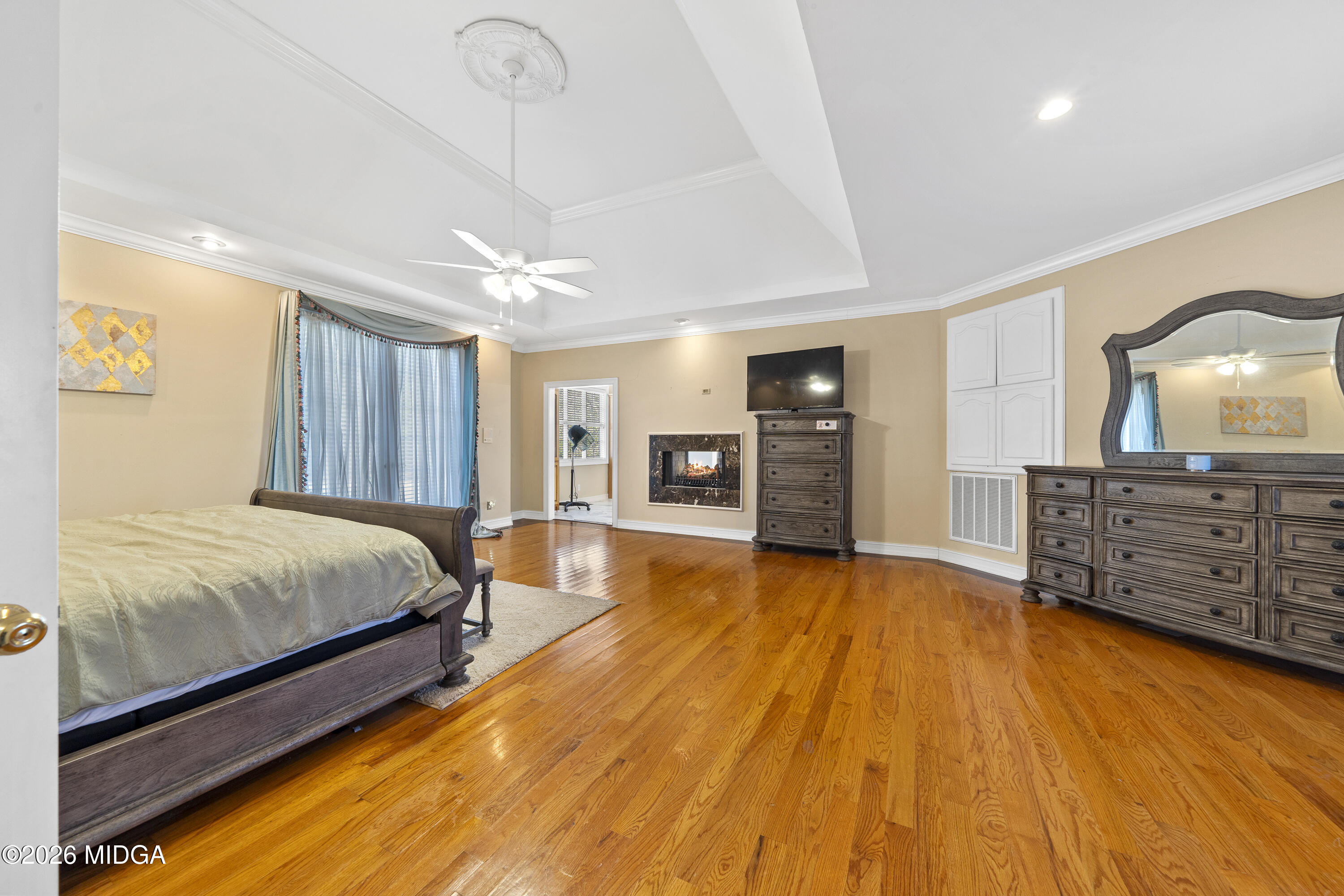 354 Lite-N-Tie Road Gray, GA 31032 - Photo 47 of 110 a spacious bedroom with a bed a dresser and a chandelier