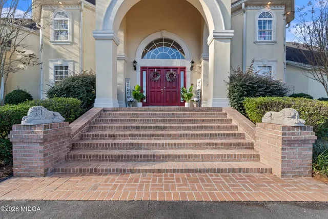 a backyard of a house with a yard and outdoor seating