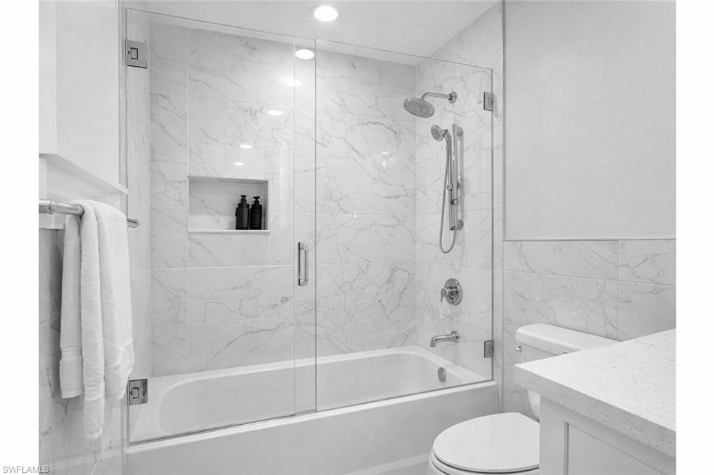 7395 Stonegate Drive Naples, FL 34109 - Photo 32 of 45 a bathroom with a shower bathtub and toilet