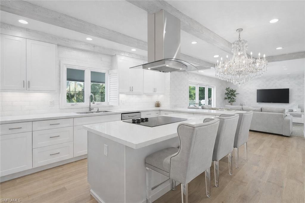 7395 Stonegate Drive Naples, FL 34109 - Photo 7 of 45 a kitchen with a white table chairs and a window