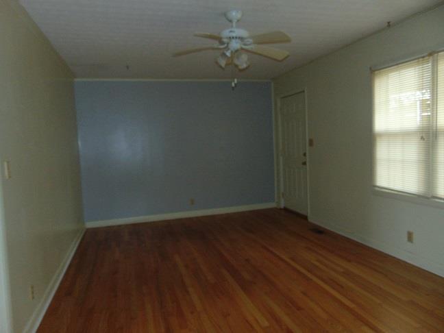 36 South Patrick Road Fayetteville, TN 37334 - Photo 2 of 11 an empty room with wooden floor fan and windows
