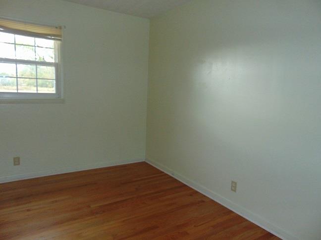 36 South Patrick Road Fayetteville, TN 37334 - Photo 5 of 11 an empty room with wooden floor and windows