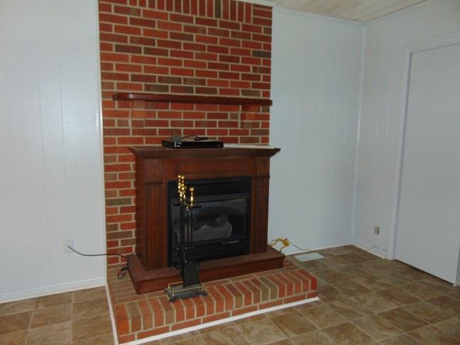 36 South Patrick Road Fayetteville, TN 37334 - Photo 10 of 11 a view of an empty room with wooden floor a fireplace