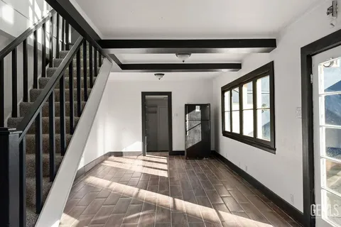a view of a hallway with wooden floor and entryway