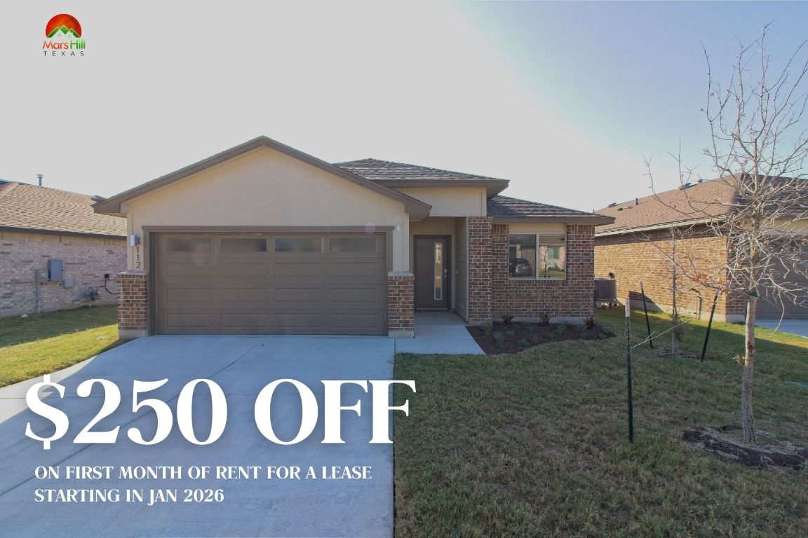 View of front of home featuring concrete driveway, a front yard, brick siding, an attached garage, and stucco siding