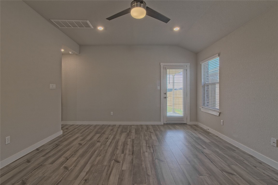 112 Halford Road Georgetown, TX 78633 - Photo 15 of 37 Empty room with light wood-type flooring, recessed lighting, vaulted ceiling, and ceiling fan