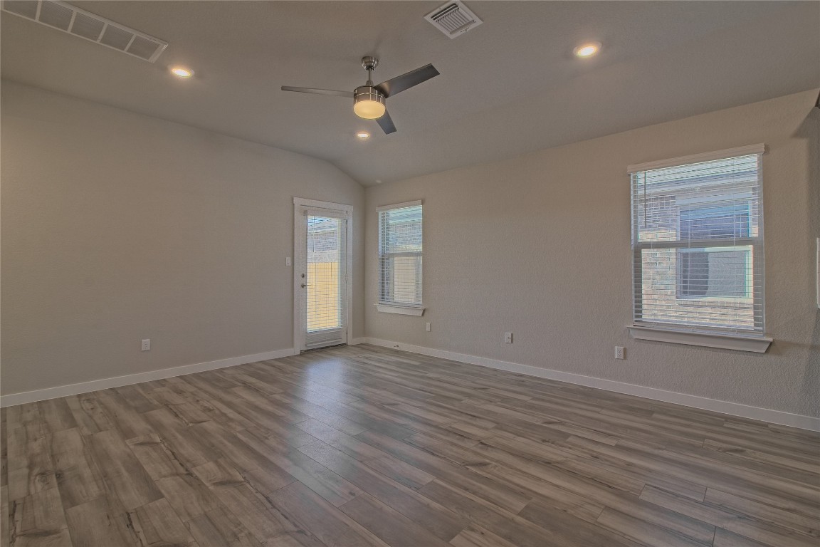 112 Halford Road Georgetown, TX 78633 - Photo 16 of 37 Unfurnished room featuring light wood-style floors, ceiling fan, recessed lighting, and vaulted ceiling