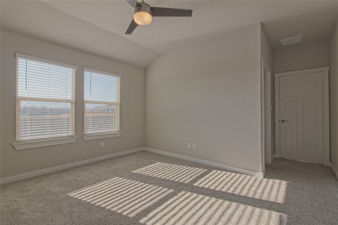 112 Halford Road Georgetown, TX 78633 - Photo 19 of 37 Carpeted empty room featuring lofted ceiling and a ceiling fan