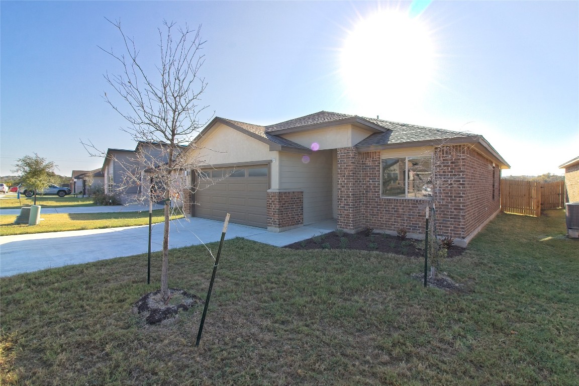 112 Halford Road Georgetown, TX 78633 - Photo 2 of 37 View of front of home with brick siding, concrete driveway, and a front yard