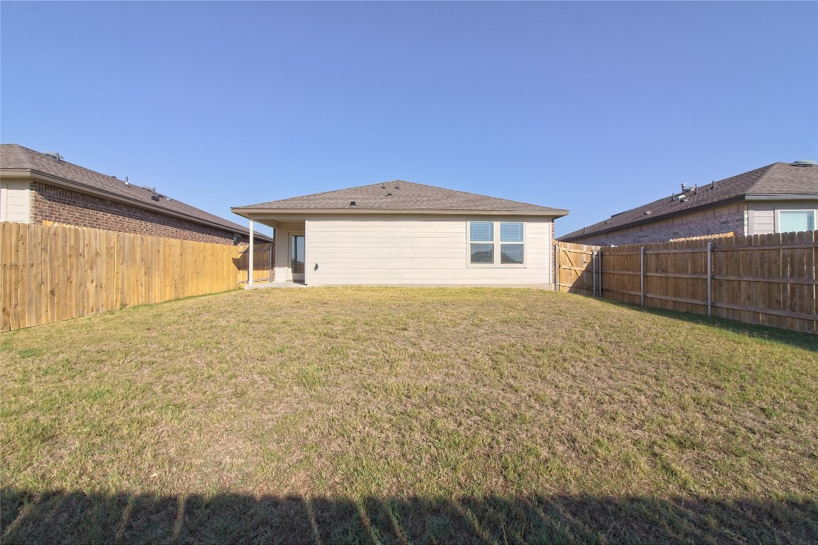 112 Halford Road Georgetown, TX 78633 - Photo 26 of 37 Rear view of house featuring a fenced backyard and a patio