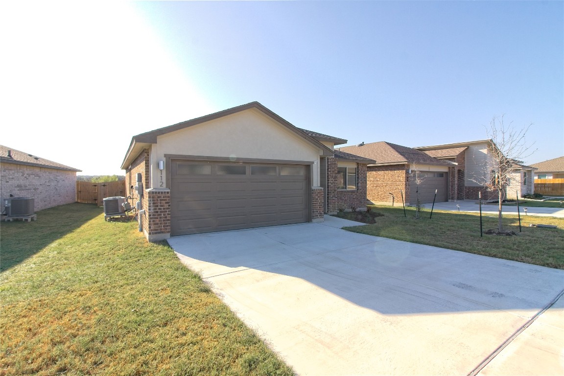 112 Halford Road Georgetown, TX 78633 - Photo 3 of 37 Ranch-style house with brick siding, driveway, stucco siding, and an attached garage