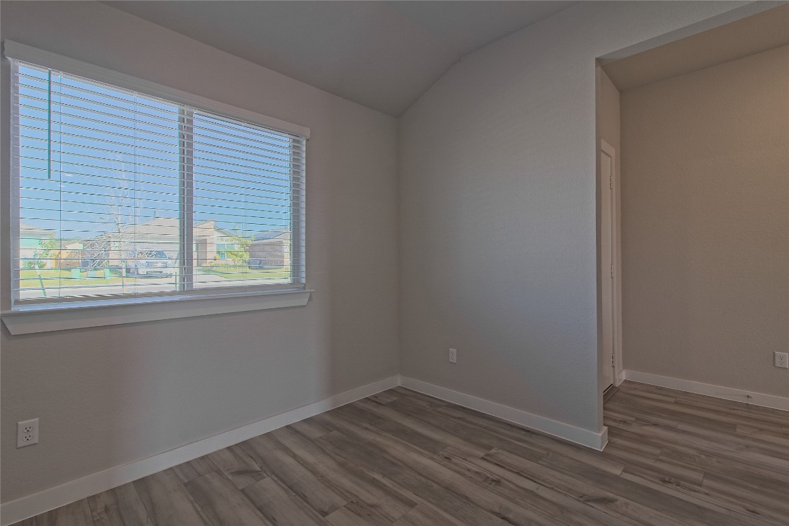 112 Halford Road Georgetown, TX 78633 - Photo 6 of 37 Empty room featuring lofted ceiling and light wood-type flooring