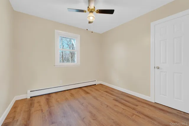 wooden floor in an empty room with a window