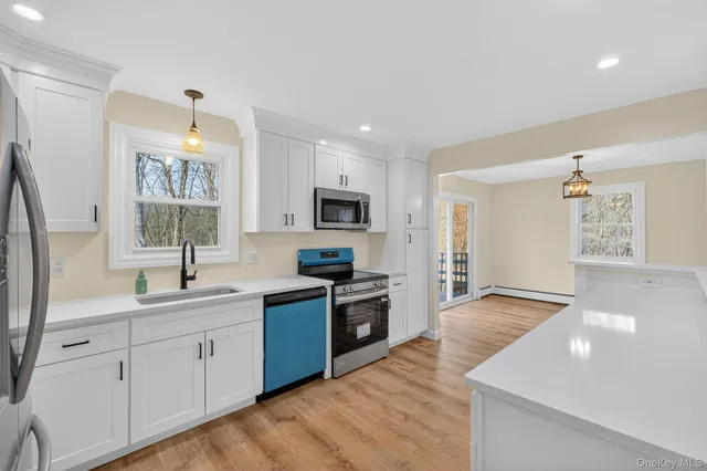 a kitchen with a sink stove and cabinets