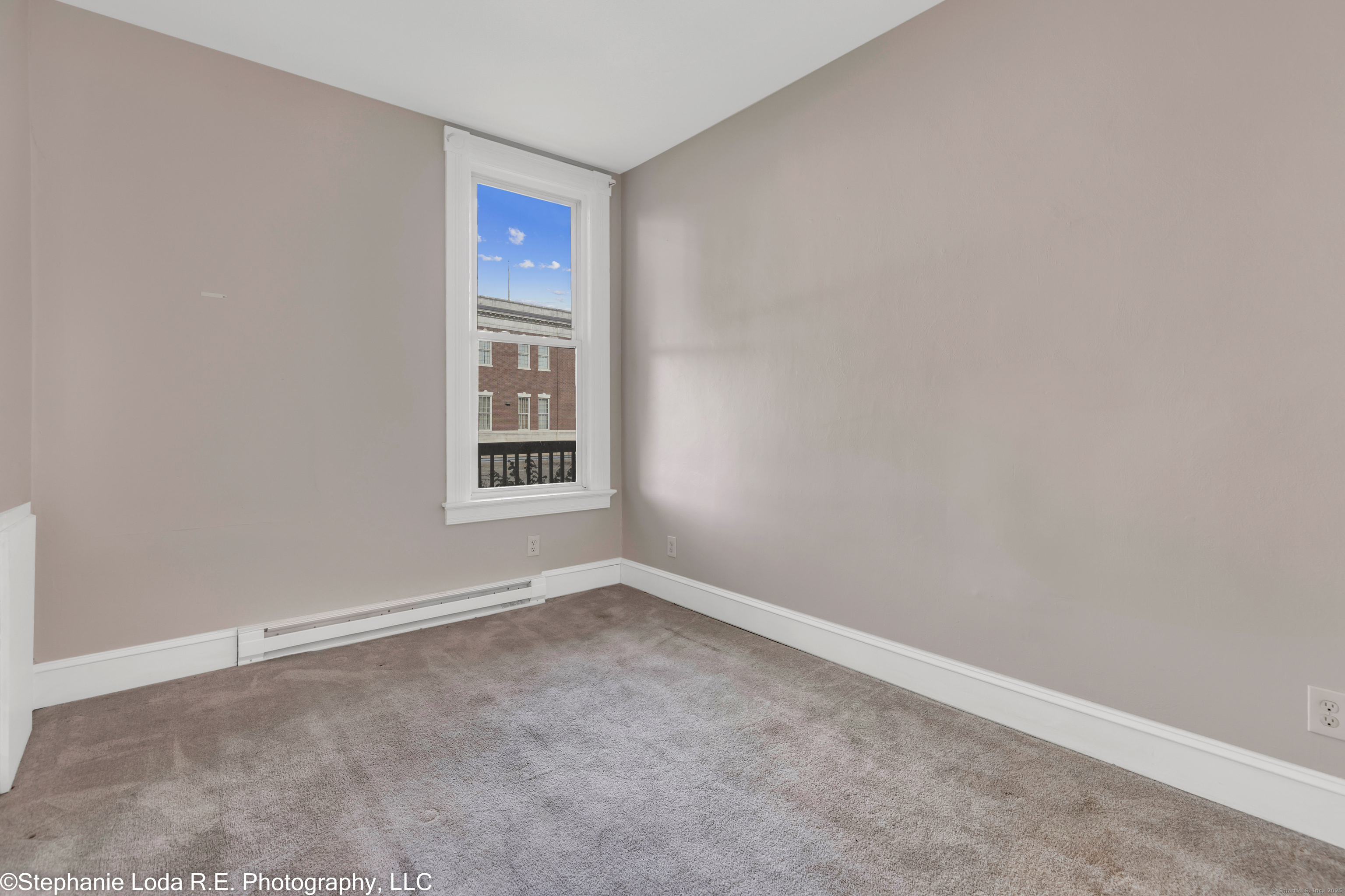 82-86 Water Street, Unit 2 Torrington, CT 06790 - Photo 22 of 23 a view of an empty room with a window