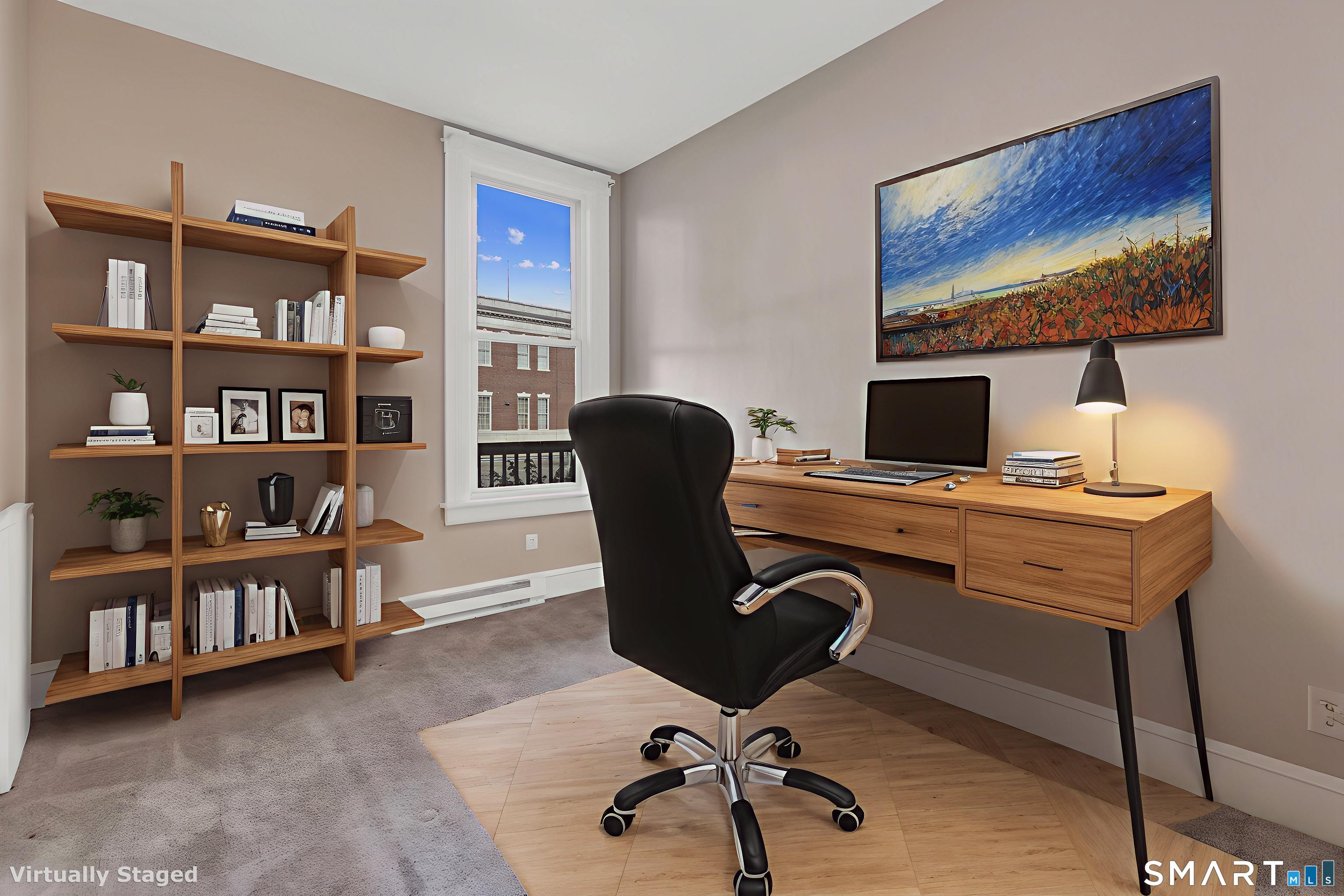 82-86 Water Street, Unit 2 Torrington, CT 06790 - Photo 5 of 23 a view of a workspace with furniture and a book shelf